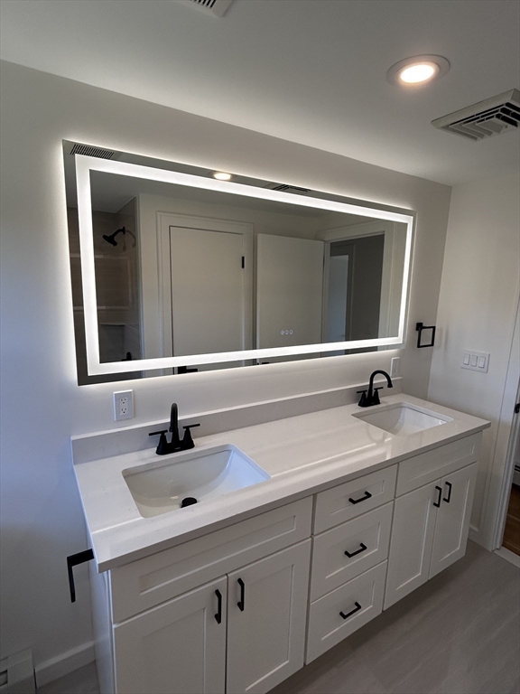 585 North Eastern Avenue Fall River, MA 02720 - Photo 15 of 26 a bathroom with a sink and a mirror