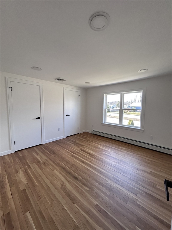 585 North Eastern Avenue Fall River, MA 02720 - Photo 17 of 26 an empty room with wooden floor and windows