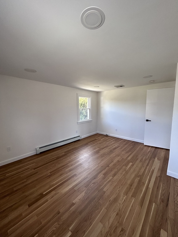 585 North Eastern Avenue Fall River, MA 02720 - Photo 18 of 26 an empty room with wooden floor and windows