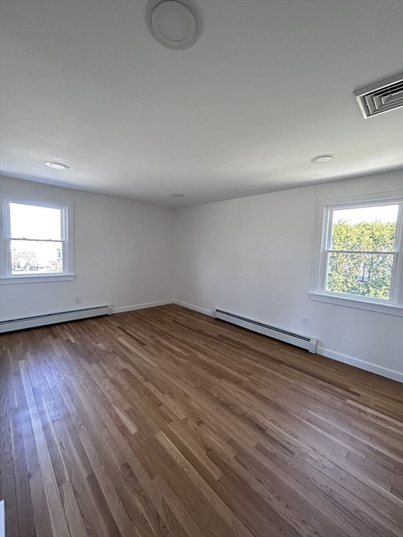 585 North Eastern Avenue Fall River, MA 02720 - Photo 19 of 26 an empty room with wooden floor and windows