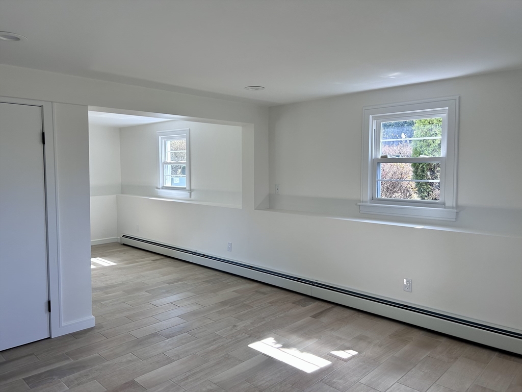 585 North Eastern Avenue Fall River, MA 02720 - Photo 23 of 26 a view of an empty room with wooden floor and a window