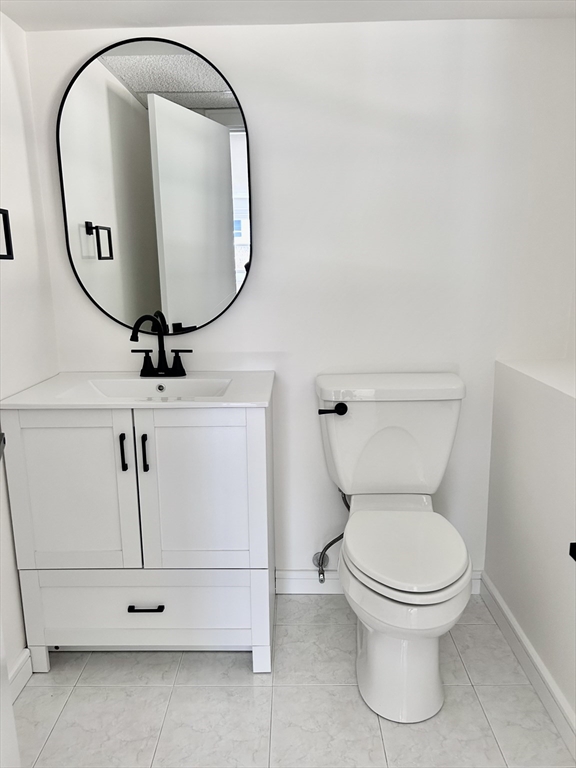 585 North Eastern Avenue Fall River, MA 02720 - Photo 25 of 26 a bathroom with a toilet and a mirror