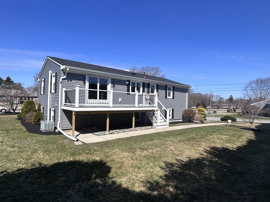 585 North Eastern Avenue Fall River, MA 02720 - Photo 3 of 26 a view of a house with a big yard and large trees