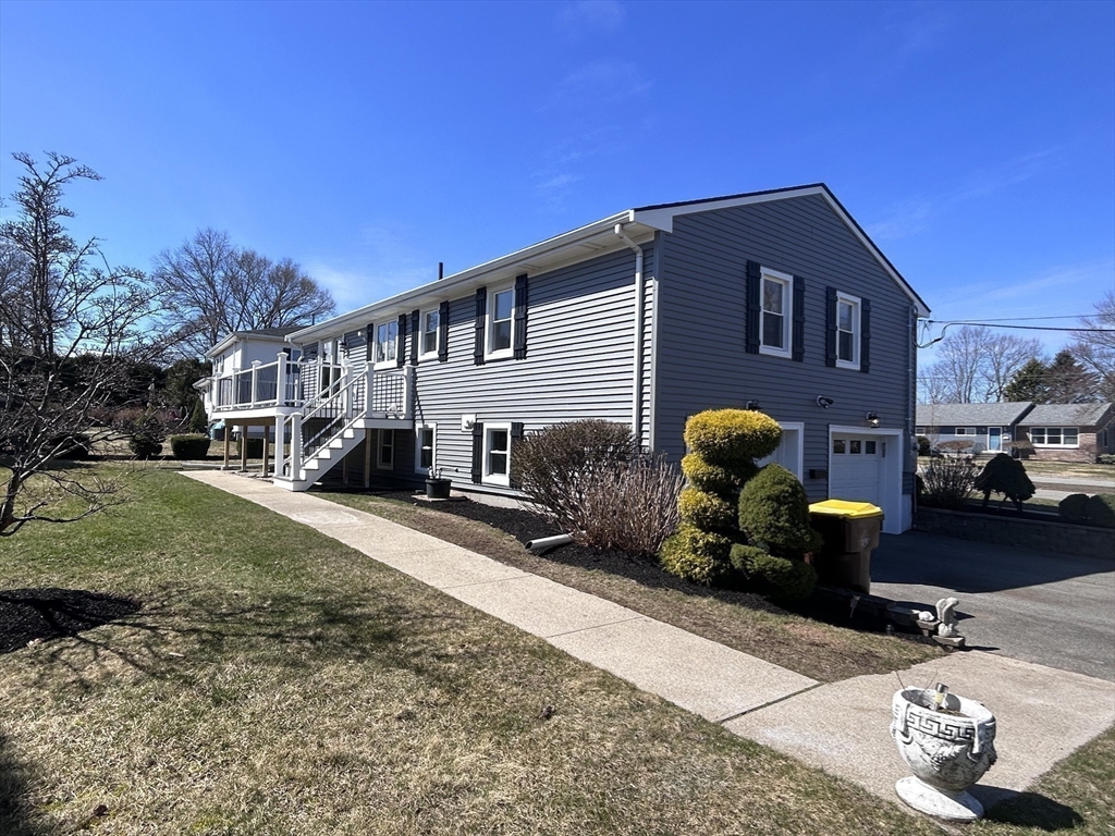 585 North Eastern Avenue Fall River, MA 02720 - Photo 4 of 26 a front view of a house with a yard