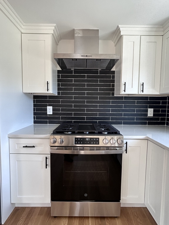 585 North Eastern Avenue Fall River, MA 02720 - Photo 8 of 26 a kitchen with a stove and white cabinets