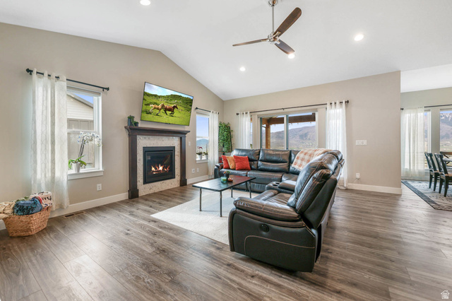 4527 North Seven Bridges Road Eden, UT 84310 - Photo 11 of 65 Living area with a ceiling fan, wood finished floors, recessed lighting, a glass covered fireplace, and vaulted ceiling