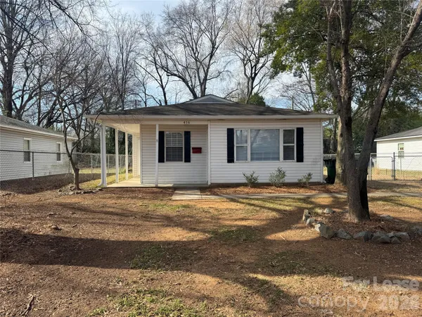 a house that has a tree in front of it