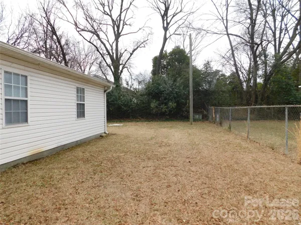 a backyard of a house with lots of trees