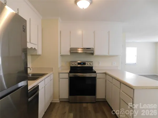 a kitchen with a sink stove and cabinets