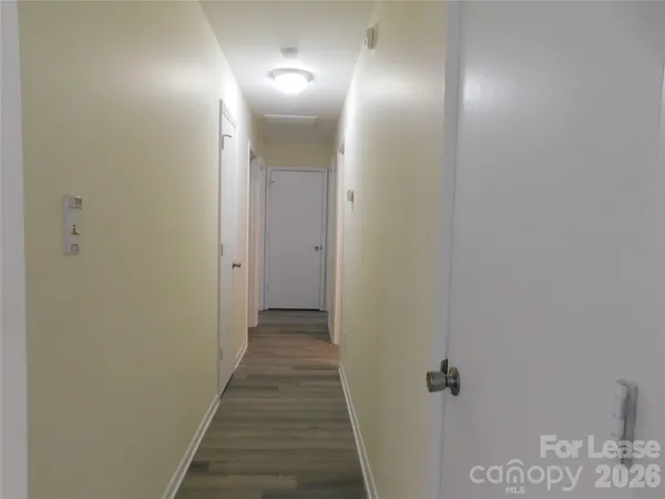 a view of a hallway with wooden floor