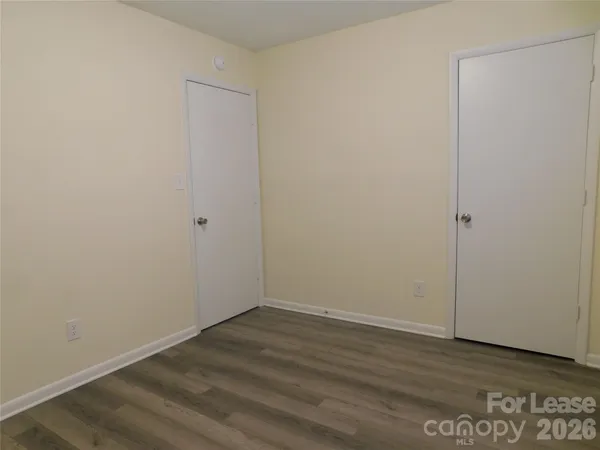 an empty room with wooden floor