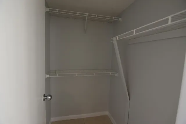 an empty room with a ceiling fan and a window