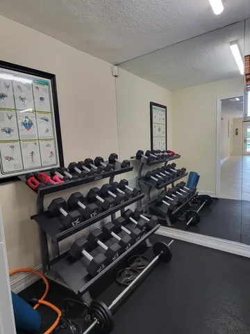 a view of house with yard and sitting area