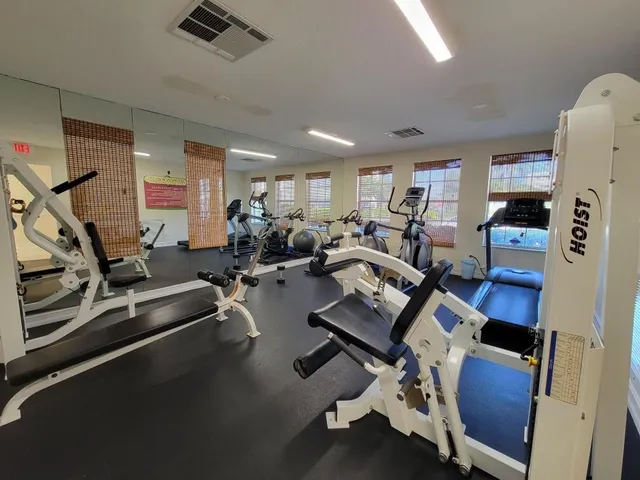 a view of a house with a swimming pool and a table and chairs
