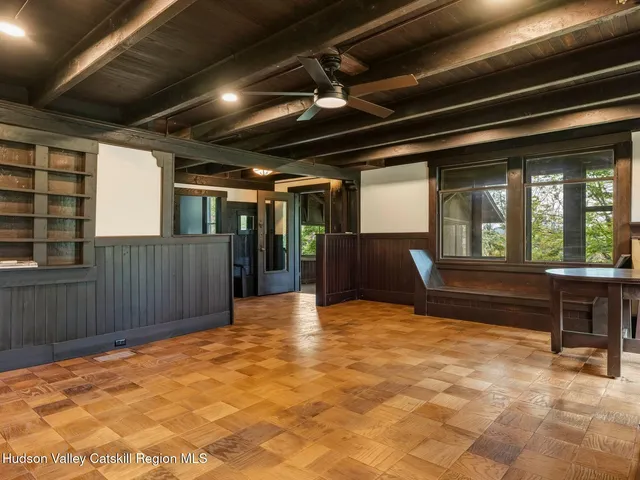 a view of an empty room with a fireplace and a large window