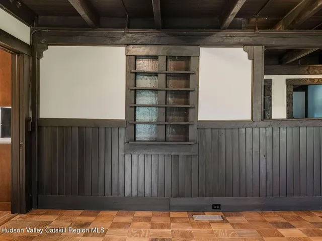a view of empty room with fireplace and windows