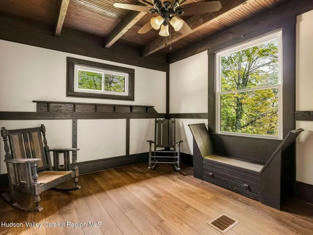 a view of patio with wooden floor and furniture