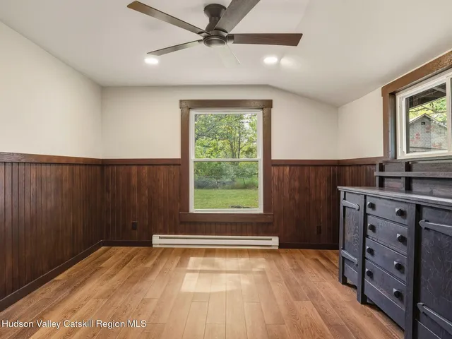 a room with a dresser and a window