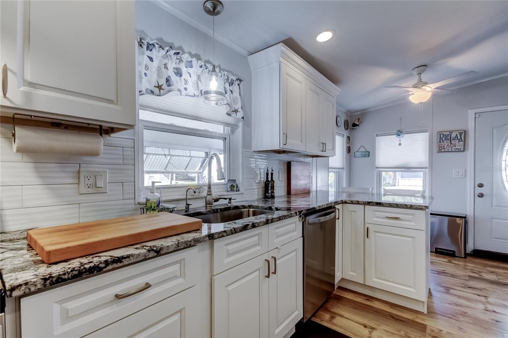 7 Frangipani Circle, Unit 7 Largo, FL 33770 - Photo 15 of 45 a kitchen with kitchen island granite countertop a sink cabinets stainless steel appliances and a counter space
