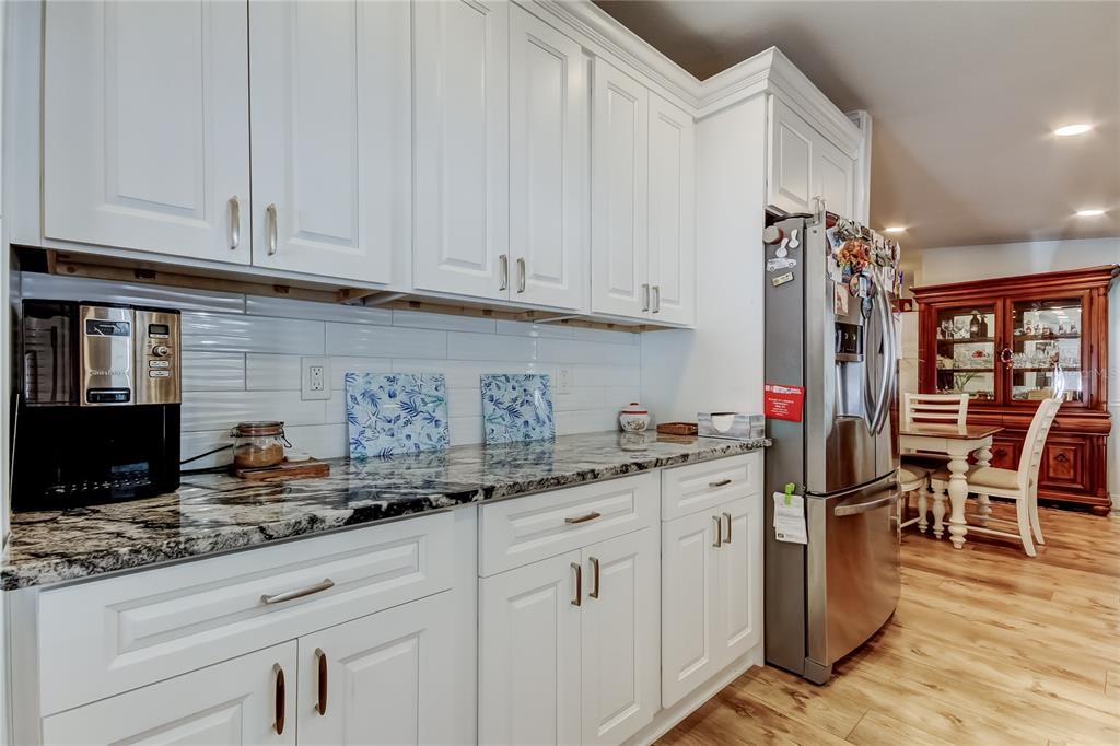 7 Frangipani Circle, Unit 7 Largo, FL 33770 - Photo 16 of 45 a kitchen with white cabinets and sink