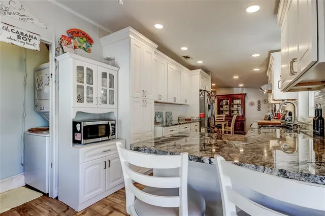 a kitchen with stainless steel appliances granite countertop a sink and cabinets