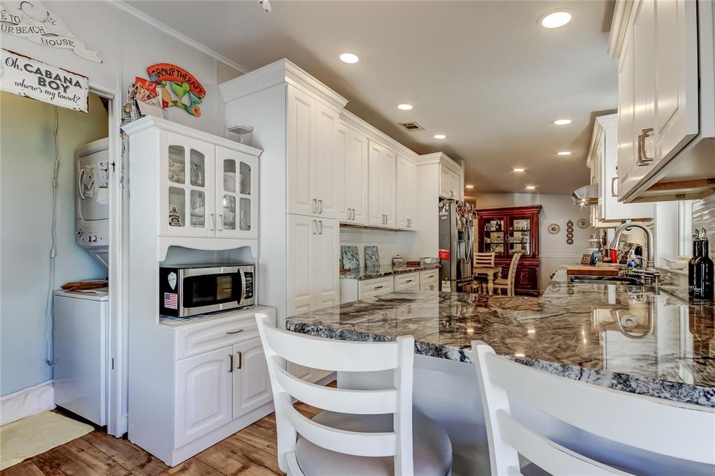 7 Frangipani Circle, Unit 7 Largo, FL 33770 - Photo 20 of 45 a kitchen with stainless steel appliances granite countertop a sink and cabinets