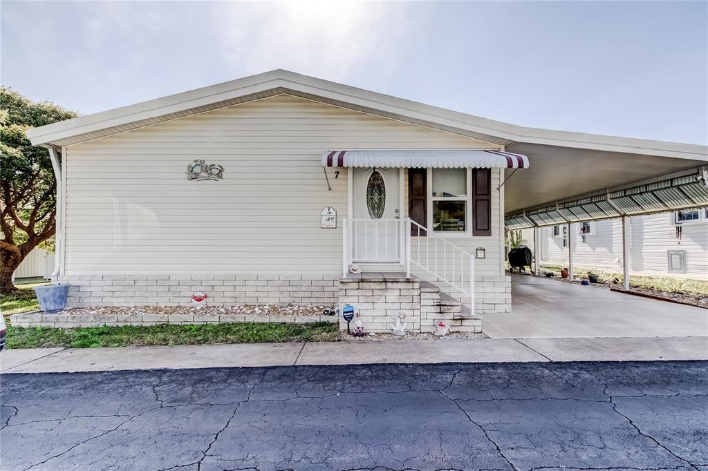 7 Frangipani Circle, Unit 7 Largo, FL 33770 - Photo 2 of 45 a front view of a house with a yard