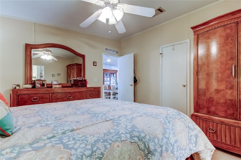 7 Frangipani Circle, Unit 7 Largo, FL 33770 - Photo 26 of 45 a bedroom with a large bed and a chandelier