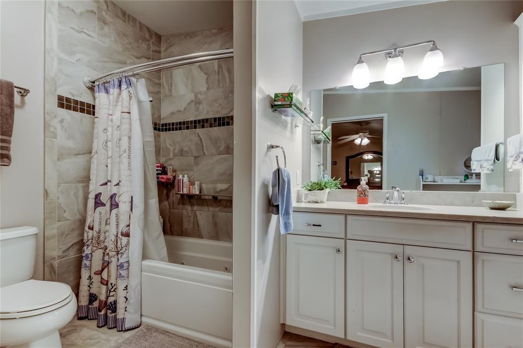 7 Frangipani Circle, Unit 7 Largo, FL 33770 - Photo 27 of 45 a bathroom with a sink a toilet and shower