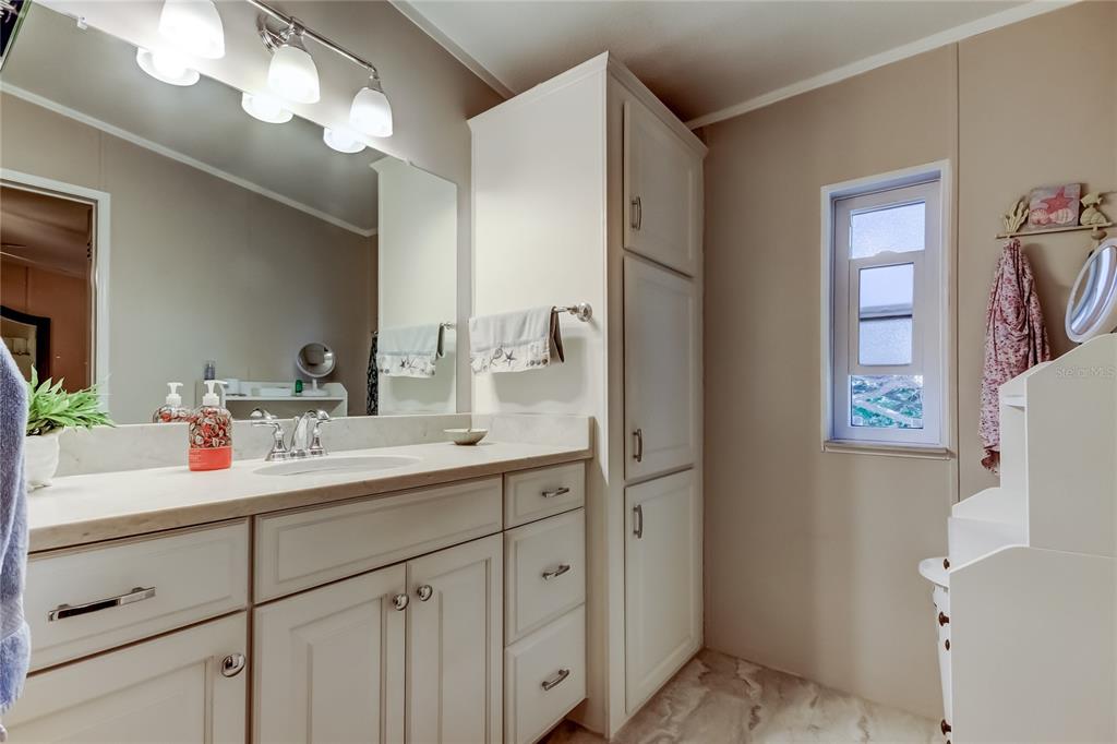 7 Frangipani Circle, Unit 7 Largo, FL 33770 - Photo 28 of 45 a bathroom with a sink and a mirror