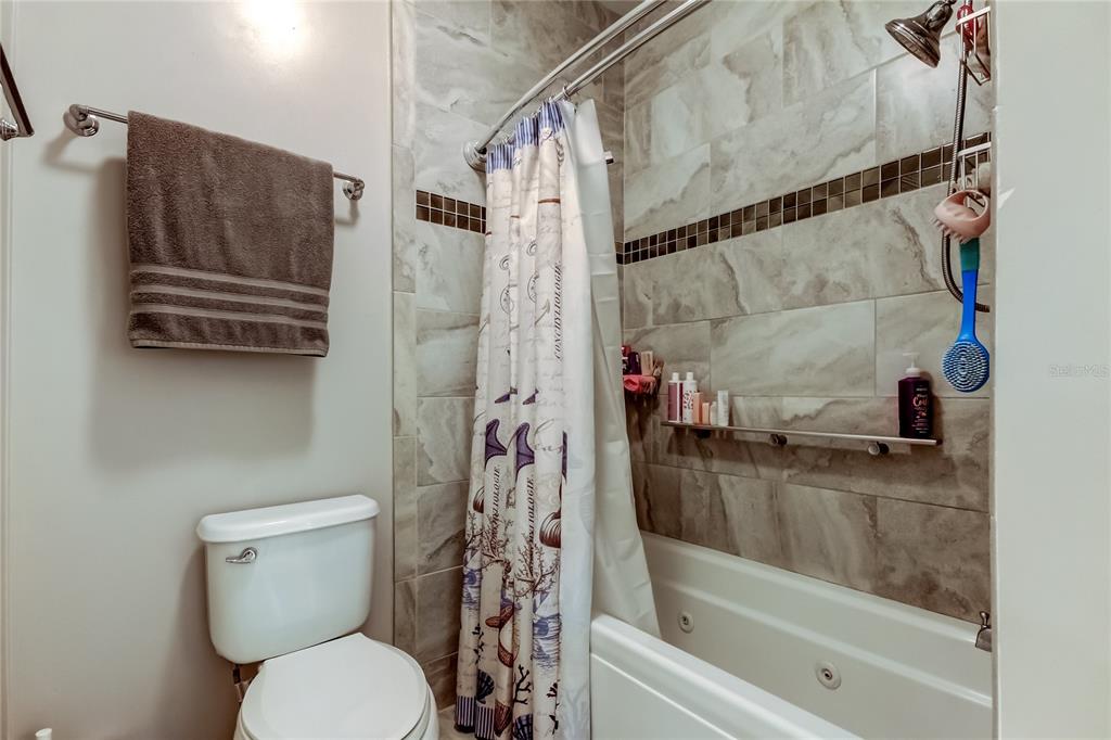 7 Frangipani Circle, Unit 7 Largo, FL 33770 - Photo 29 of 45 a bathroom with a toilet and a shower