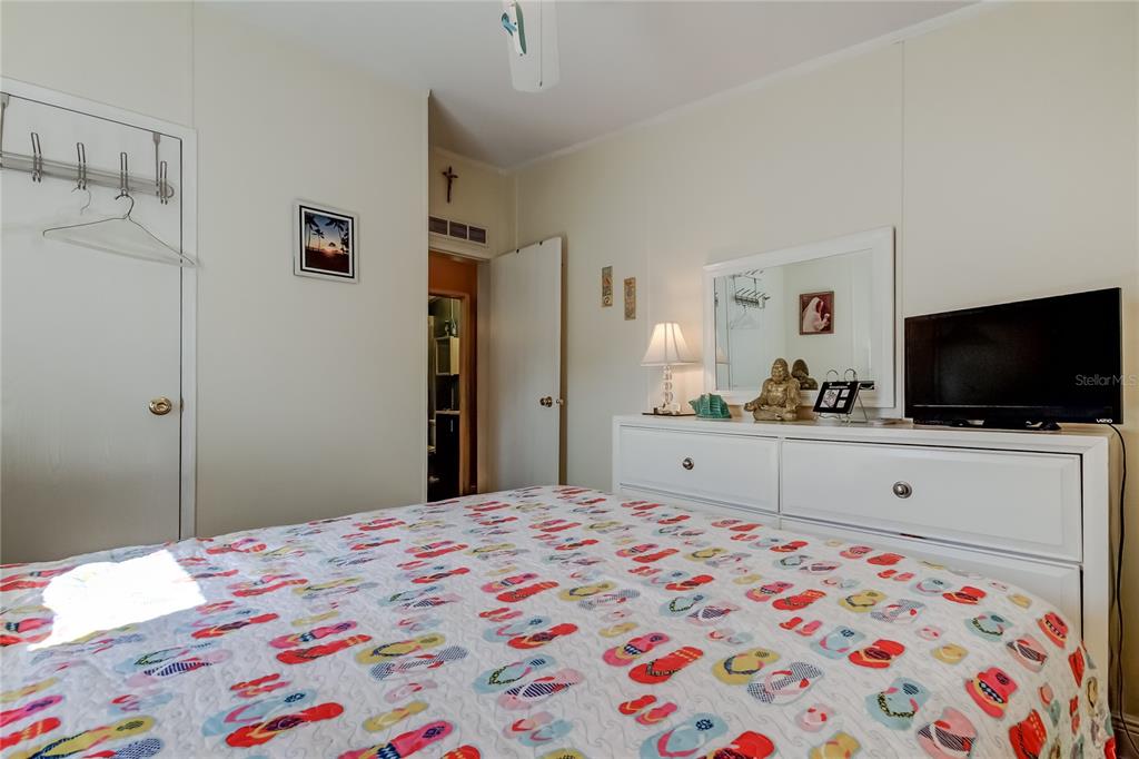 7 Frangipani Circle, Unit 7 Largo, FL 33770 - Photo 33 of 45 a bedroom with a bed and a flat screen tv