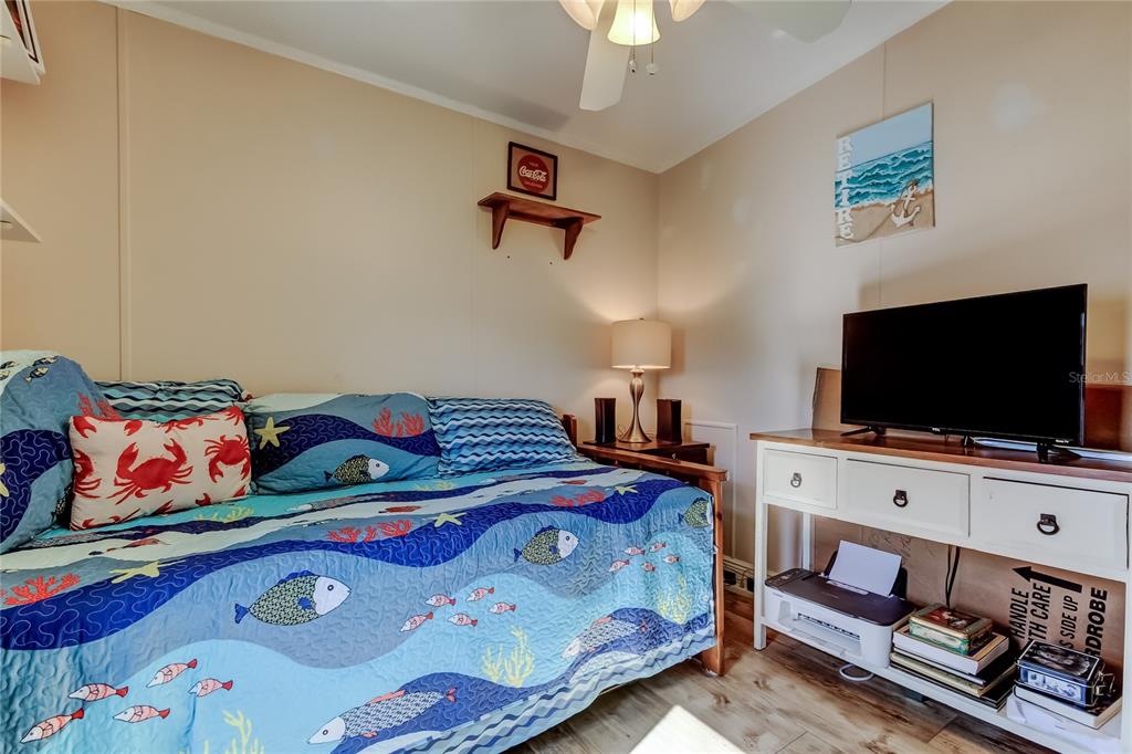 7 Frangipani Circle, Unit 7 Largo, FL 33770 - Photo 35 of 45 a bedroom with bed and a flat screen tv