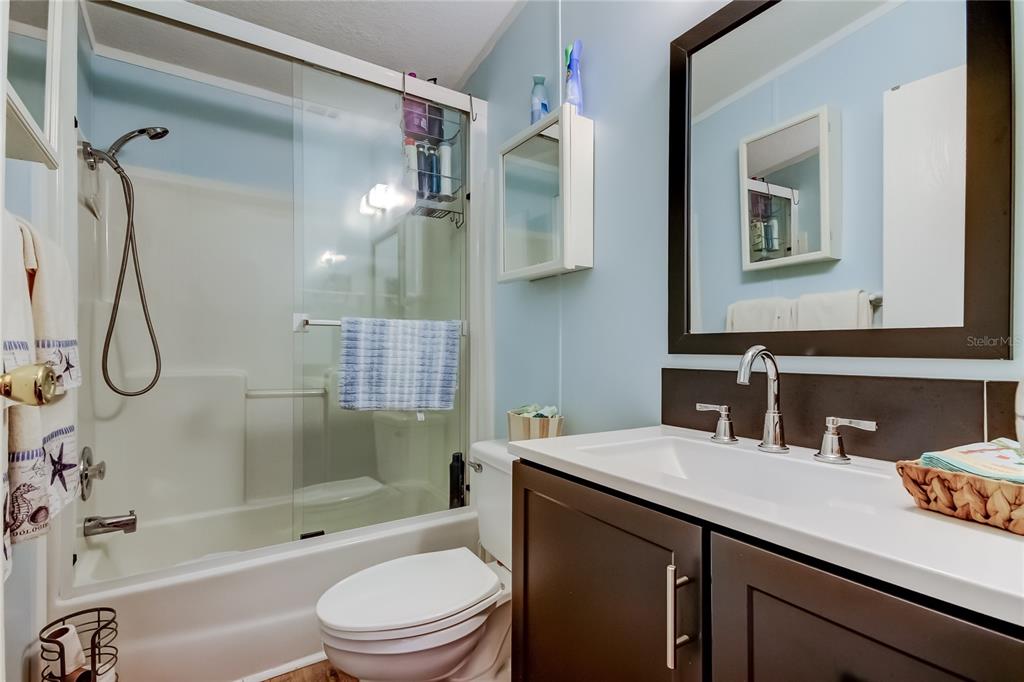 7 Frangipani Circle, Unit 7 Largo, FL 33770 - Photo 37 of 45 a bathroom with a sink a toilet and shower