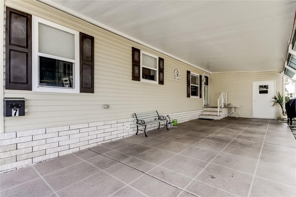 7 Frangipani Circle, Unit 7 Largo, FL 33770 - Photo 40 of 45 a backyard of a house with table and chairs