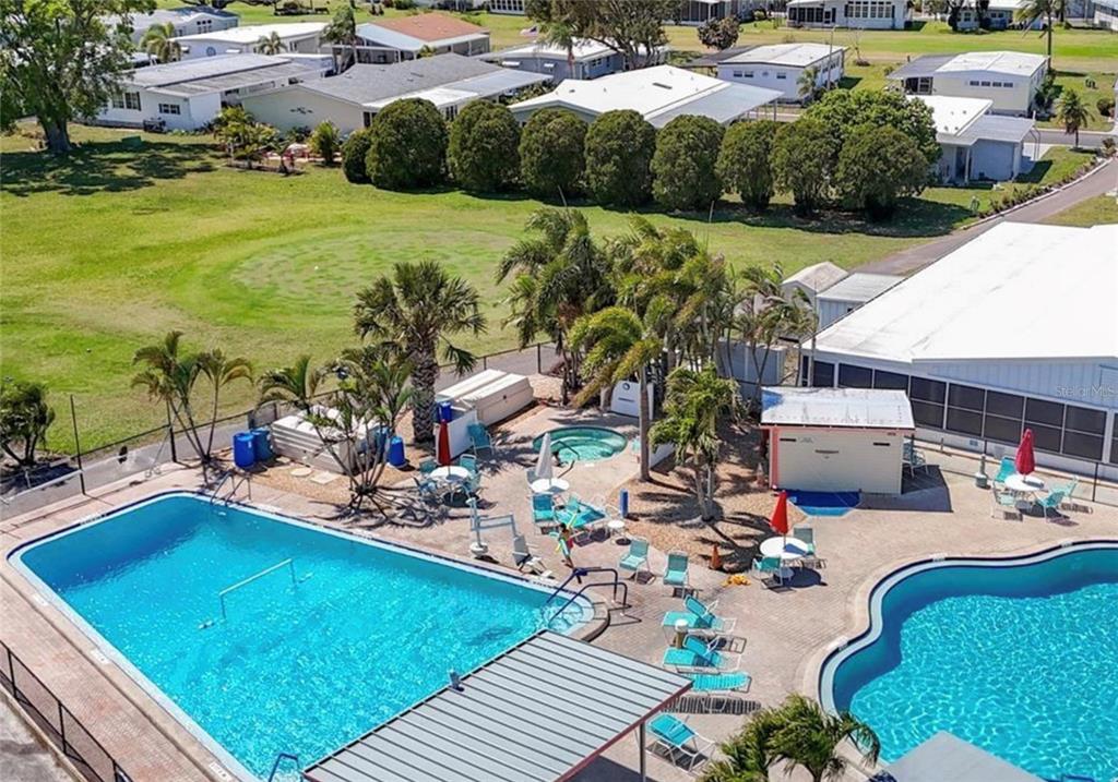 7 Frangipani Circle, Unit 7 Largo, FL 33770 - Photo 43 of 45 a view of a swimming pool with a patio and garden