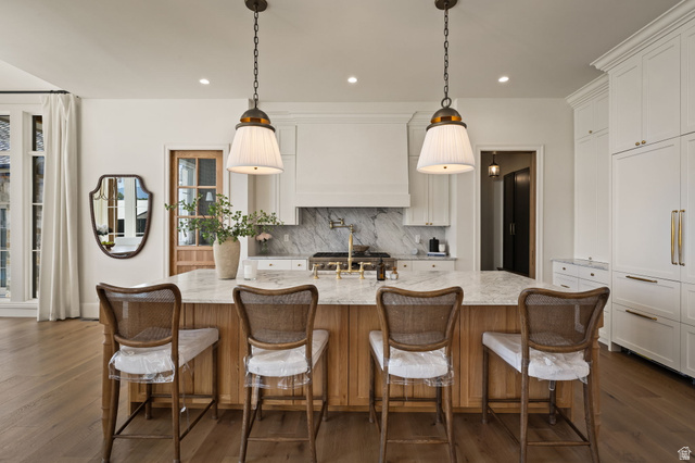 478 South Maple Lakes Drive Mapleton, UT 84664 - Photo 7 of 51 Central kitchen island with a natural wood-finish base, light-toned countertop, and dual pendant lighting