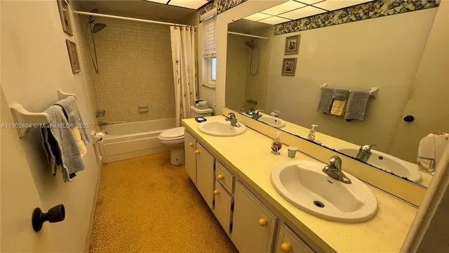 a bathroom with a tub sink and mirror