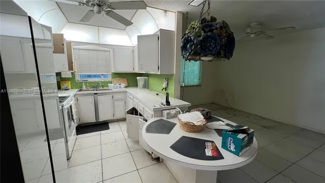 a kitchen with a sink a table and chairs