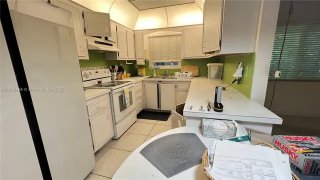 a kitchen with a sink appliances and cabinets