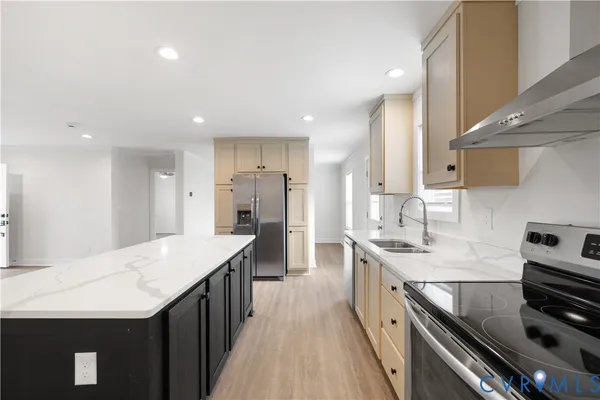 a kitchen with stainless steel appliances a sink stove and refrigerator