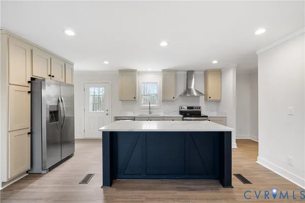 a kitchen with stainless steel appliances a sink stove and refrigerator
