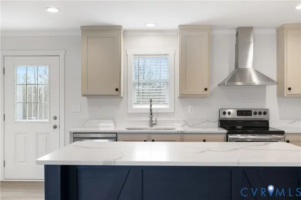 a kitchen with stainless steel appliances a sink a stove and a refrigerator