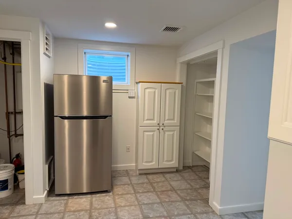 a view of a utility room with cabinets