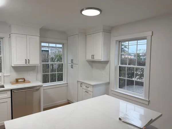 a kitchen with stainless steel appliances granite countertop a refrigerator stove top oven and sink