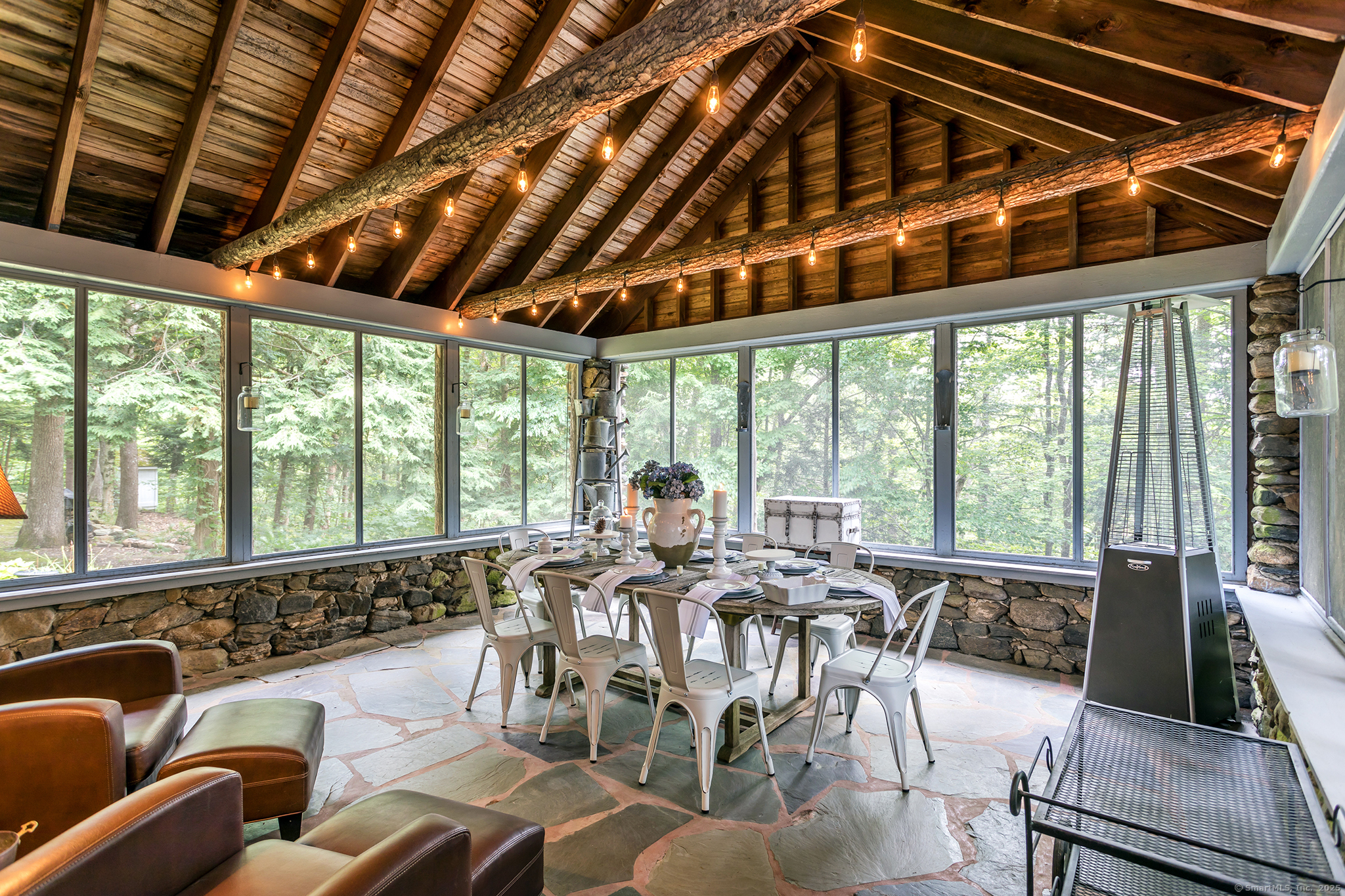 60 Leach Hollow Road Sherman, CT 06784 - Photo 12 of 24 a view of a patio with couches chairs dining table and chairs with wooden floor