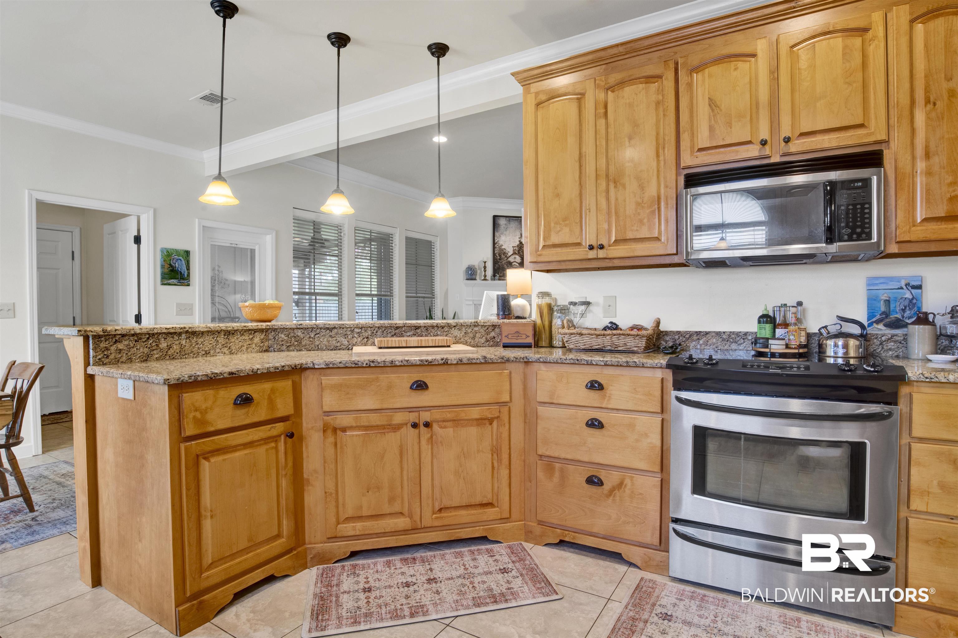 10368 Gayfer Rd Extension Fairhope, AL 36532 - Photo 10 of 43 Kitchen featuring wood cabinetry, granite countertops, stainless steel appliances, and tile flooring