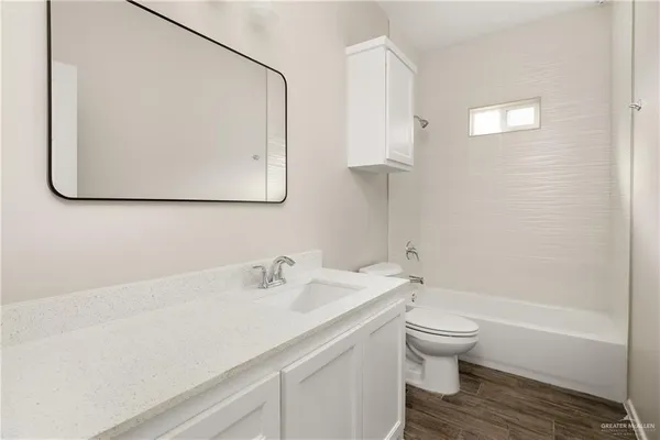 a bathroom with a sink toilet and vanity