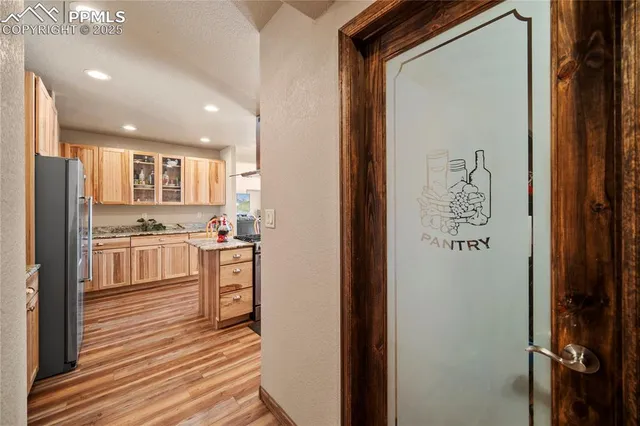 a kitchen with stainless steel appliances granite countertop a refrigerator and a stove