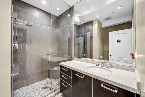 a bathroom with a sink double vanity and a shower